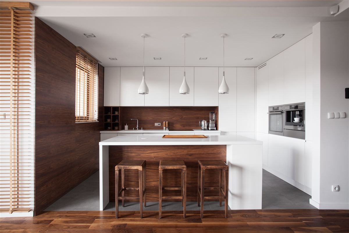 Open-concept kitchen with walnut cabinetry — representative finish example