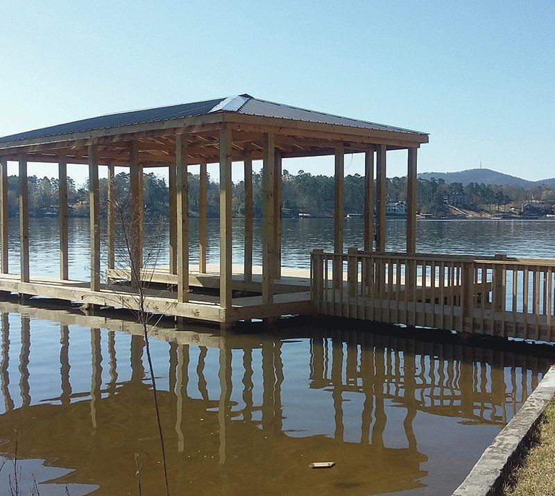 Covered lakeside boat dock built by GRV